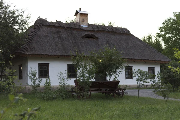 Paard en wagen onder het venster Oekraïense hut. — Stockfoto