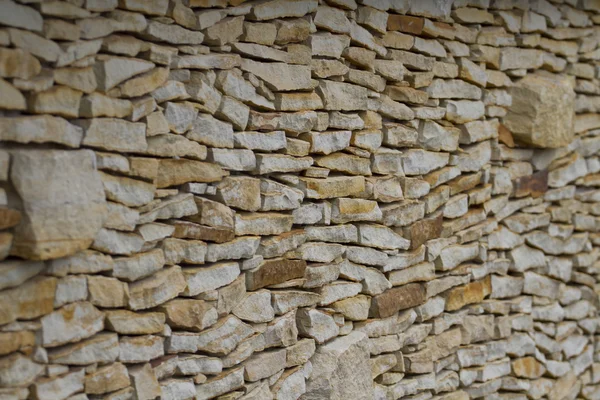 Wall made of pieces sandstone protruding clump. — Stock Photo, Image