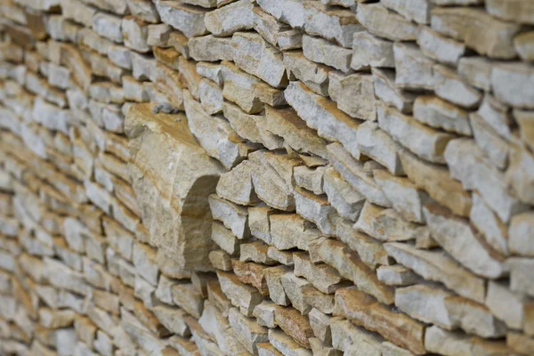 Muur gemaakt van stukken zandsteen uitstekende klomp. — Stockfoto