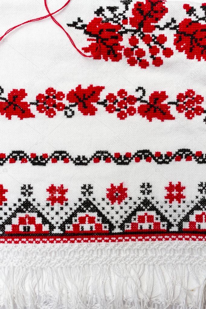 Pattern embroidered on the towel with red and black thread.