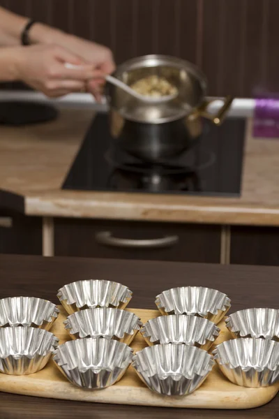 Metal molds for cakes on the kitchen table.