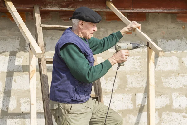 Carpenter with a screwdriver in his hand. Royalty Free Stock Photos