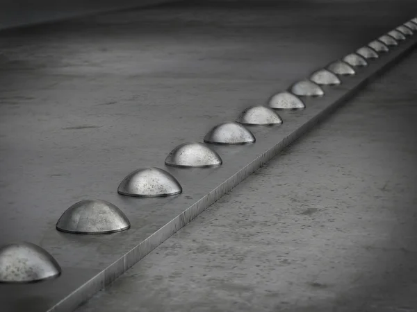 Row of rivets on the metal grunge background — Stock Photo, Image