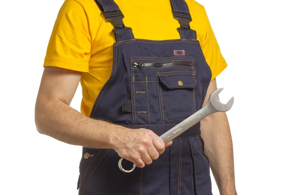 Worker in a helmet and a yellow T-shirt — Stock Photo, Image