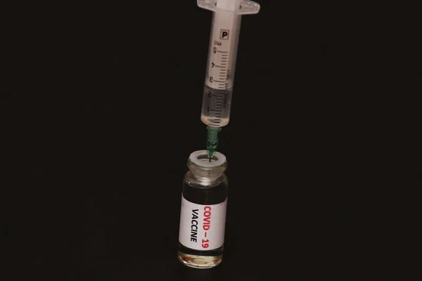 Concept Combating Coronavirus Covid Black Background Jar Vaccine Syringe Concept — Stock Photo, Image