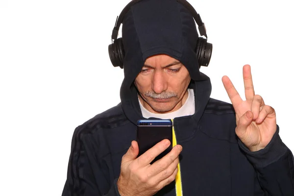 Man Sports Jacket Hood His Head Listens Music Headphones His — Stock Photo, Image