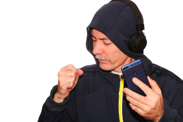 Man Sports Jacket Hood His Head Listens Music Headphones His — Stock Photo, Image