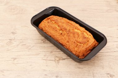 Oven-baked cupcake in a metal form on a wooden background. Baking concept - dessert on wooden background.