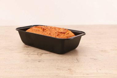 Oven-baked cupcake in a metal form on a wooden background. Baking concept - dessert on wooden background.