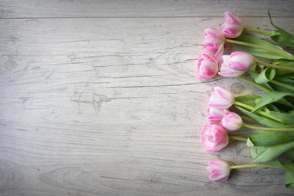 Tulips on a wooden background — Stock Photo, Image