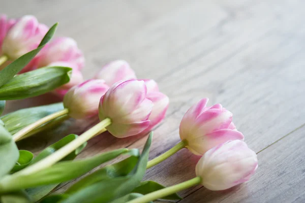 Tulips on a wooden background — Stock Photo, Image