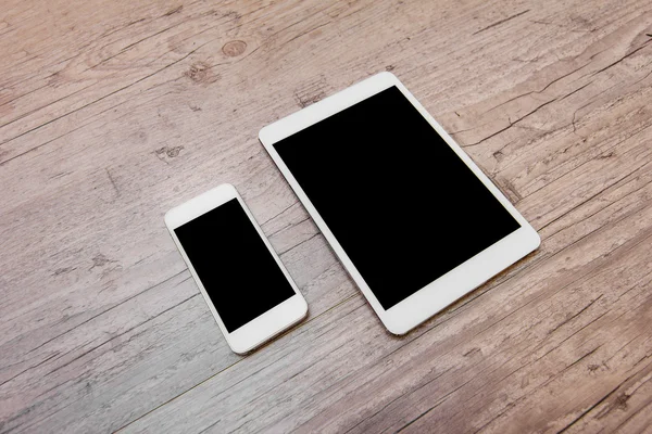 Smartphone and a tablet on the wooden background — Stock Photo, Image