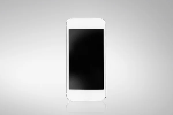 Smartphone blanco sobre fondo gris — Foto de Stock