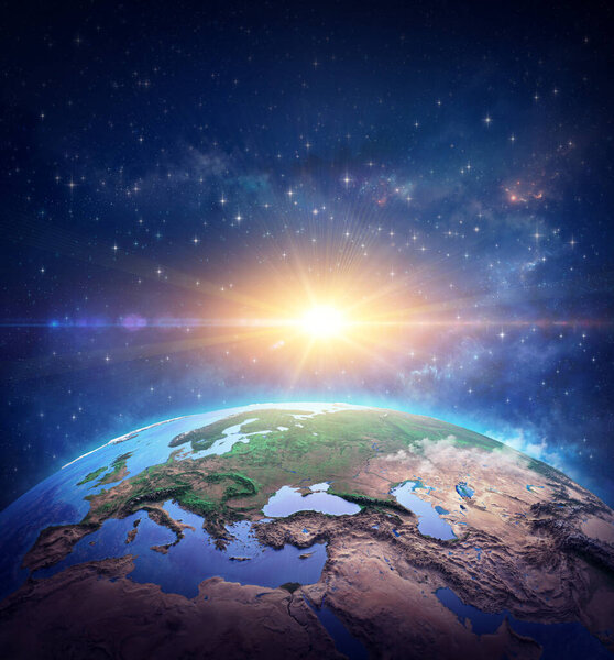 Surface of Planet Earth, space view of the World focused on Europe. Rising sun shining into deep space, star cluster and nebula far behind. 3D illustration - Elements of this image furnished by NASA