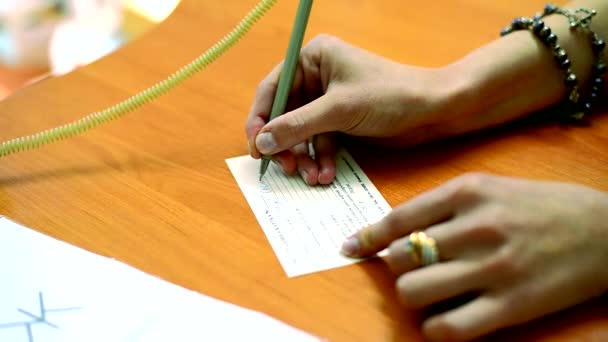 Woman filling a library card — Stock Video