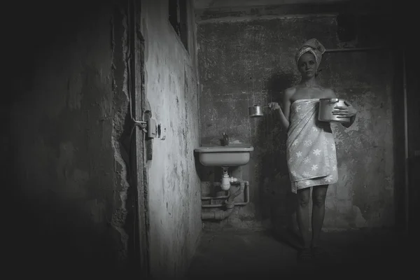 Alojamento barato. Uma menina senta-se em uma cadeira em um velho apartamento . — Fotografia de Stock