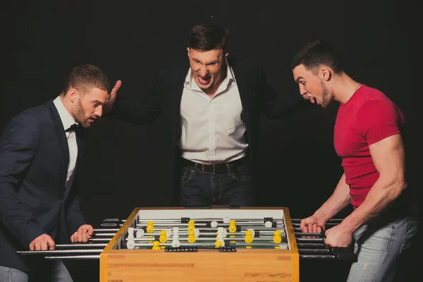 Boys play table football. The emotions of winning and losing. — Stock Photo, Image