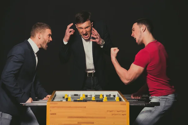 Boys play table football. The emotions of winning and losing. — Stock Photo, Image