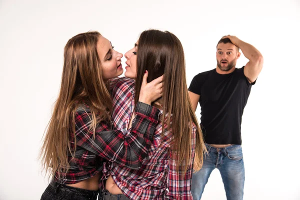 The girl kissing a girl. Man in shock. — Stock Photo, Image