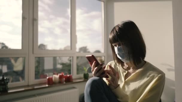 Medical Mask Woman Sits Medical Mask Holds Mobile Phone Her — Stock Video