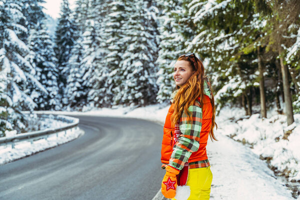 Winter. A woman walks in a snow-covered park.