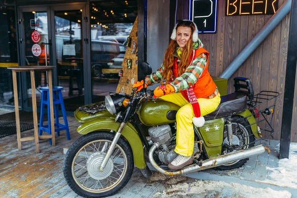 Motorcycle with a sidecar. A woman is sitting on a motorcycle with a sidecar.