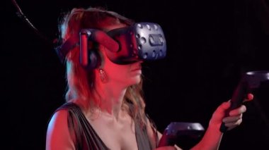 Sanal gerçeklik. Bir kadın sanal gerçeklik kaskıyla oyun oynuyor..