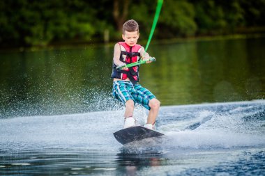 A child riding in the Wakeboarding clipart