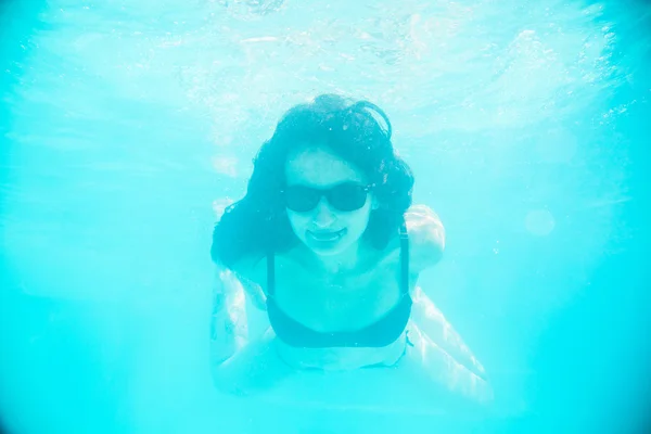 Chica nadando bajo el agua en gafas de sol — Foto de Stock