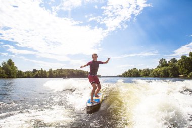 Girl rides a study wakesurfing clipart