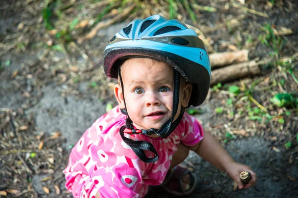 Little girl in a sundress and bicycle helmets — Stock Photo, Image