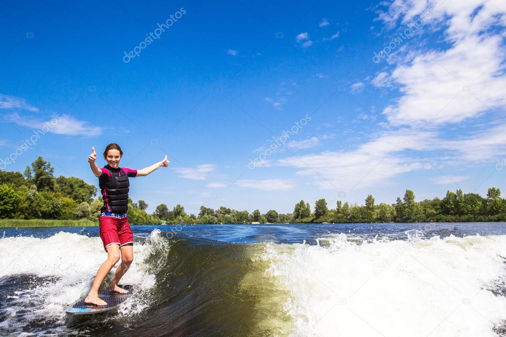 Girl rides a study wakesurfing
