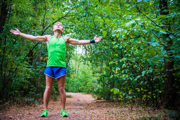 Man doing exercises in the woods — Stok fotoğraf