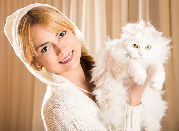 La chica sostiene un gato blanco esponjoso — Foto de Stock
