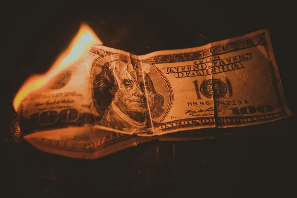 One hundred dollar bill on fire. Treatment with toning effect — Stock Photo, Image