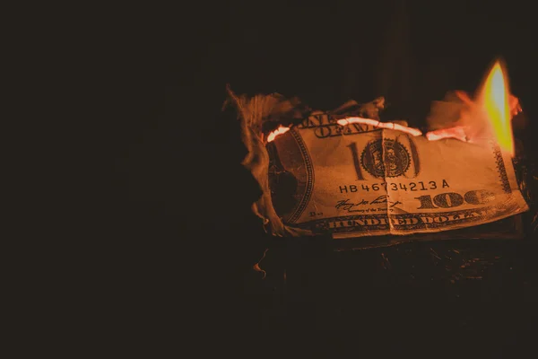 One hundred dollar bill on fire. Treatment with toning effect — Stock Photo, Image