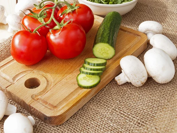 Cucumbers, tomatoes, mushrooms and arugula — Stock Photo, Image