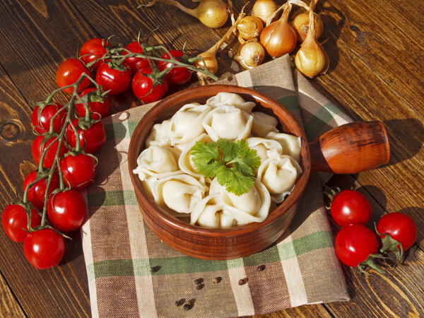 Пельмени с мясом на деревянном столе
