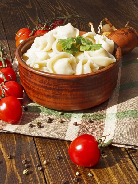 Dumplings with meat on a wooden table — Stock Photo, Image