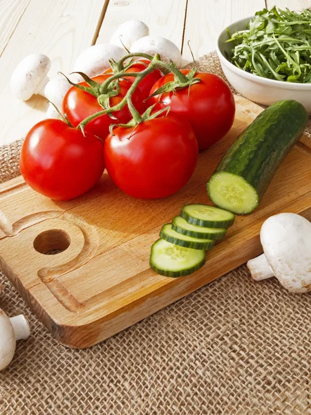 Cucumbers, tomatoes, mushrooms and arugula — Stock Photo, Image