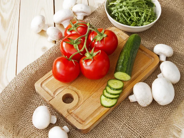 Cucumbers, tomatoes, mushrooms and arugula — Stock Photo, Image