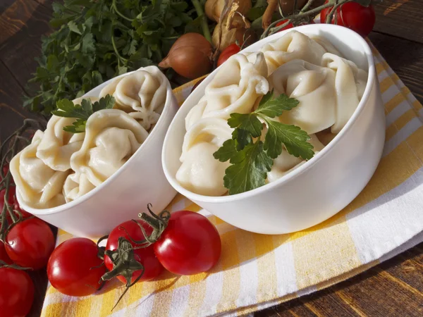 Dumplings with meat on a wooden table — Stock Photo, Image