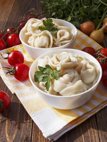 Dumplings with meat on a wooden table — Stock Photo, Image