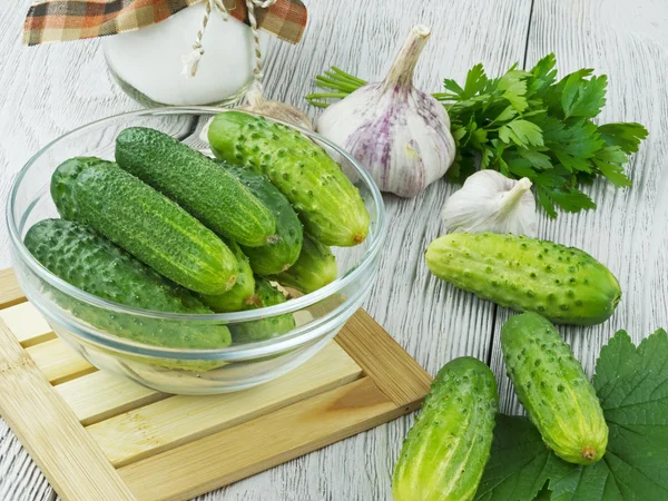 Färska gurkor på ett träbord — Stockfoto