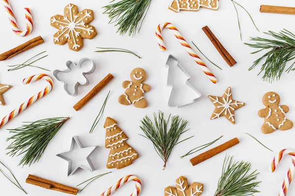 stock image Christmas, winter, new year composition. Pattern made of Fir tree branches, cinnamon sticks, candies, gingerbread on white background. Flat lay, top view