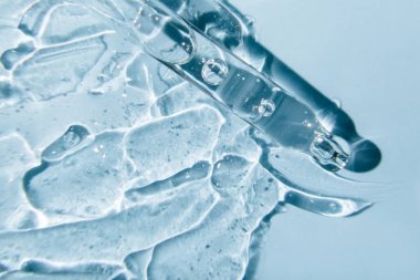 Makyaj ve kozmetik doku arka planı, cilt bakımı ürünü. Pipetli desen jeli serumu.