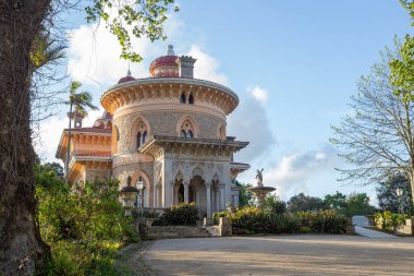 Monserrate sarayı, mavi gökyüzünün altında yemyeşil bahçelerle çevrili romantik mimari tarzını sergiliyor.