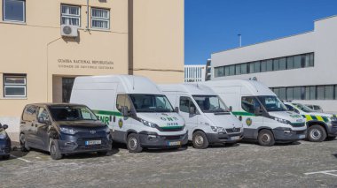 GNR polisi ve güvenlik minibüsleri Portekiz 'de bir binanın önüne park edilmiş.
