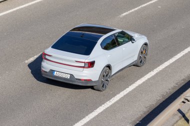 Polestar 2, açık gri bir elektrikli araba, otoyolda gidiyor.