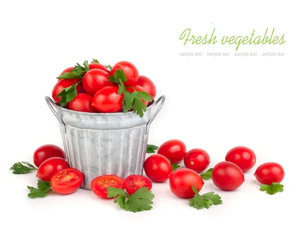 Fresh cherry tomatoes in a bucket on a white background with space for the text. — Stock Photo, Image